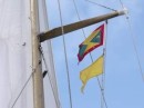 Arriving at Grenada. The Grenadan courtesy flag hoisted above the Q-Flag. A signal flag flown when arriving in a new country. It means "My vessel is healthy and I request free pratique."