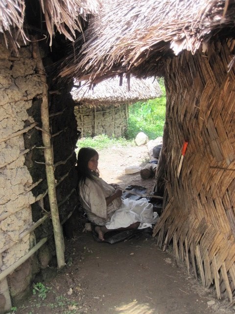 A Kogi woman weaving a strap for a mochila, a bag to hang over the shoulder)