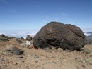 An accretion boulder. These are formed rather like snowballs rolling down a hill and getting larger as more snow is accreted. These are formed when a small rock roll down a steep slope of molten lava and it sticks to the rock.