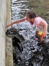 A young girl feed the sacred blue eyed eels... we were glad it was not our job as some of them were huge.