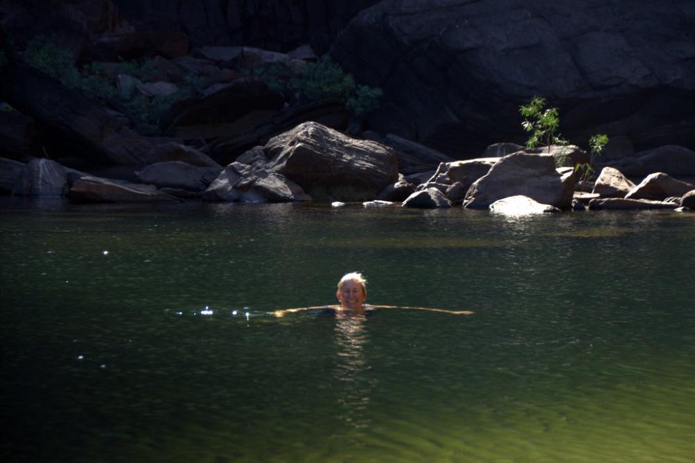 Sue swims in a natural pool