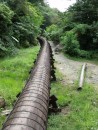 Pipeline taking water from the reservoir. Like at St Lucia this one is made of barrel like staves of wood, coated in bitumen and held together with rings of bolted studding... just like a very long barrel.