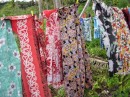 Traditional fabrics blowing in the wind to keep the pigs away from the Tarrow crops.