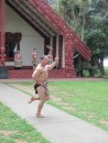 A Maori warrior performs the Haka out side the meeting house.
