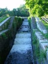The old locks minus gates used as a spillway for the River Mohawk, by-passing the new locks.