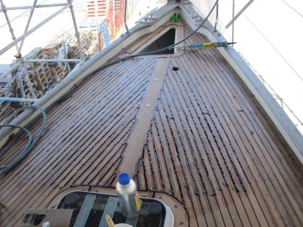 The deck after caulking has been inserted between the planks