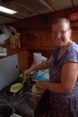 Sue making flat bread on passage in calmer times.