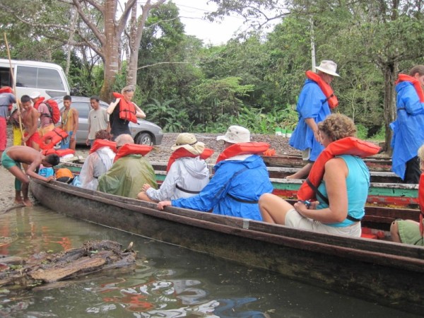 The group dons life jackets and piles into the canoes.