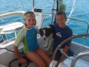 Sierra and John play with Daisy while sailing