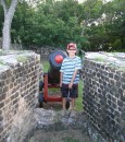 a John at Fort Rodney next to a cannon.JPG