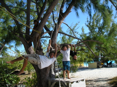 Kelby and David playing on the tree swing at Volleyball Beach.