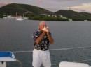 Paul blowing the conch horn at sunset.