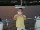 John blowing the conch horn at sunset on Mennos Birthday.