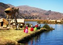 Islas Flotantes on Lake Titicaca. Good view of the reed islands, houses and watchtower. Local Uros women await a boat of tourists. 