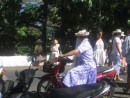 Raro: Leaving Church. This is  how almost everyone gets around, young and old - on scooters. Love this woman in her church hat! 