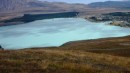 Lake Tekapo seen from above. The color, like so many glacial lakes, is a cool light turquoise-blue, but with a milky cast.