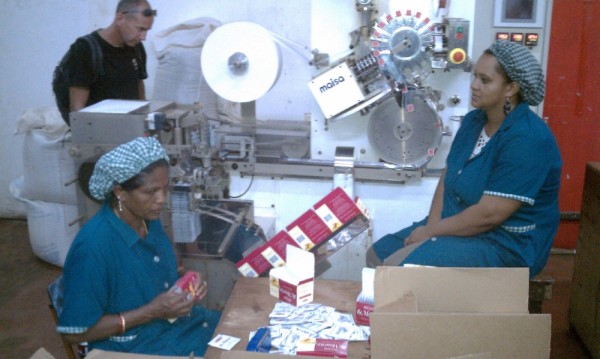 Women at the machine which places the tea in the tea bags