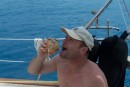 Dave, a friend and crew member of s/v Southern Cross shares in the coconut.