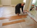 Laying a laminate wood floor at a rental.