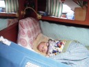 having a little snooze in our berth.  Notice the baby friendly lee cloth to keep her from traveling too far - a going away gift created by Steve and Anik at Stitches Afloat. Credit A Calfee