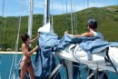Linds and Bri do their chores  -  sail cover on before going ashore to play.