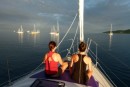 Beth & Linds doing yoga on the foredeck as the sun rises in Musket Cove.