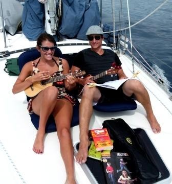 Linds & Bri practicing some ukelele tunes as we head for Waya Island  -  before the wind arrived!