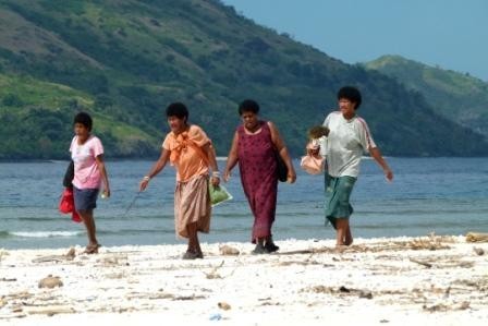 Ladies on the beach heading back to the village.