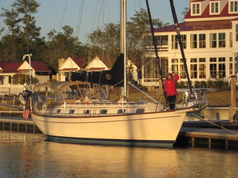 Jane stands on the foredeck in her winter finest in front of the River Dunes clubhouse.