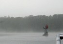 The fog, borne on a light morning breeze, lifts and settles back on the river.