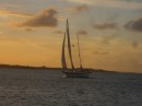A ketch comes in to Elizabeth Harbour at sunset