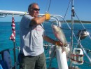 Bud and the 24-inch Mutton Snapper he caught while moored at Little Farmers Cay