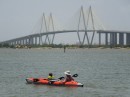 Jill and Adler kayak with the Fred Hartman bridge in the background.