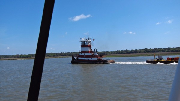 Here is the lead tug. There were three. The main tug ( Royal Engineer ) pulling the entire train of barges living quarters and pipe. The other two pull the pipe into a curve to get around the curves of the waterway