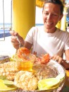 IMG_0331: Pascale dips some shrimp in butter at a beachside cafe in Mazatlan