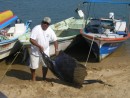 fisherman displays fish at Barra