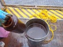 Bucket of oily surface water