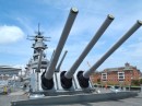 Larry is dwarfed by the 16 inch guns on the Wisconsin.