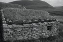 Old croft. The roof is turf, over stone, held up by wooden rafters, and then burlap lining. 