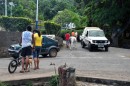 Rush hour at the main intersection in Nuku Hiva; a horse, a kid, a dog, a car, no stoplight, no street sign.
