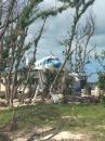 Percy’s House with the plane on the roof - Duncan Town: Note all trees gone due to the Destruction from Hurricane Irma Sept 2017