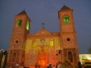 The church in the main square lit up at night.