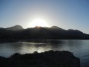 Sun disappearing behind the mountain and overlooking the anchorage in San Evaristo.