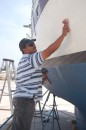 Edwardo polishing and waxing the hull.