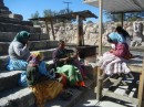 Tarahumara indian women and children weaving baskets at the train station.