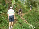 Maynard and Michael on the track up to the coffee farm before it started raining.  Charly is hacking at a fallen banana plant with his machete to clear it off the track