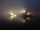 Two fishing boats departing for the Georges Bank in the fog from Yarmouth, Nova Scotia, Canada