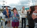 Honking and oompahing with conch shells at happy hour at the Marsh Harbor Marina.  Sharon on the left, Renae on the right and Rosmarie in between the girls trying to stay warm on the dock