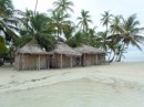 These 3 huts are for rent at the resort on Banedup.  |They contain 1 bed only.  Note the tide coming in.