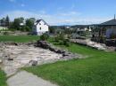 Foundations of nearby homes, the only sign that houses were once next to the little white house.  Saguenay, QC, Canada.